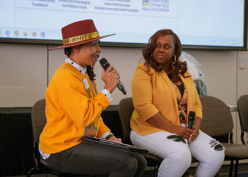 Bianca Reed facilitating the conversation among the speakers at the event.