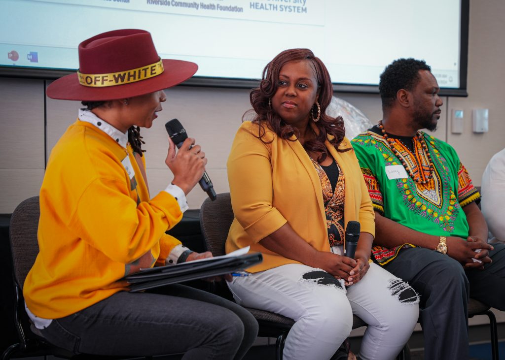 Bianca Reed facilitating the conversation among the speakers at the event.