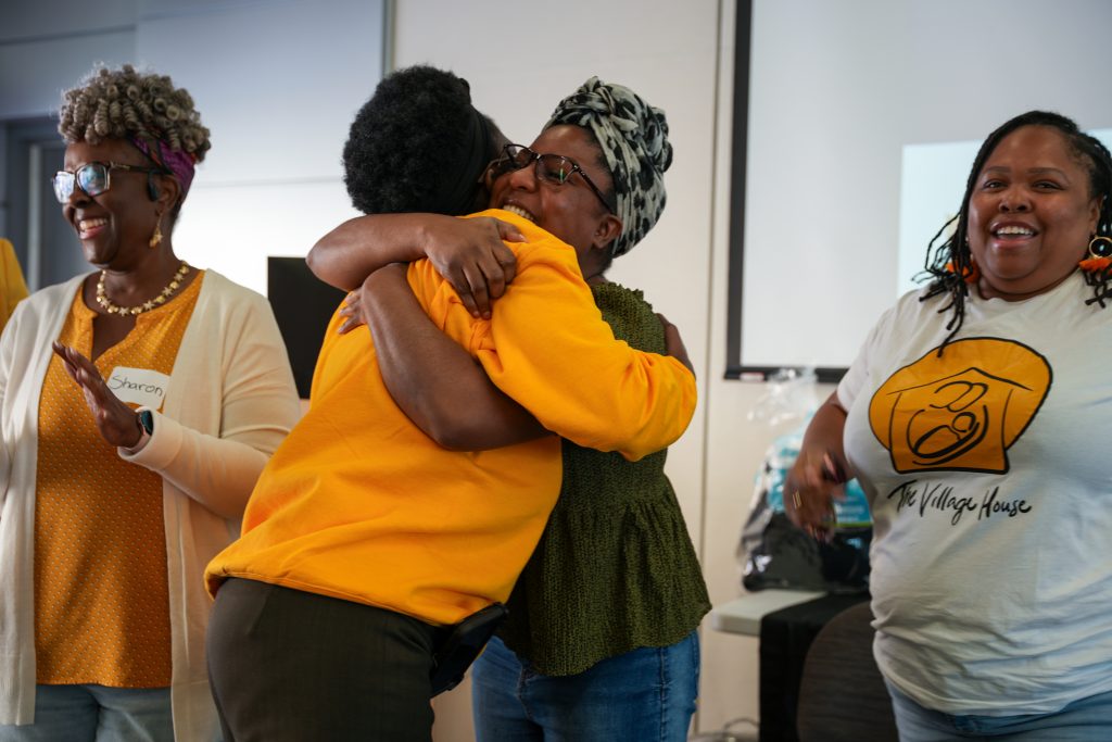 Curley Palmer and Dr. Janiel Henry hugging each other at the event.