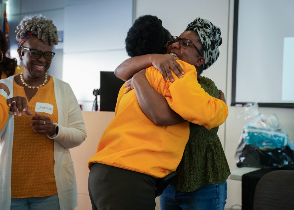 Curley Palmer and Dr. Janiel Henry hugging each other at the event.