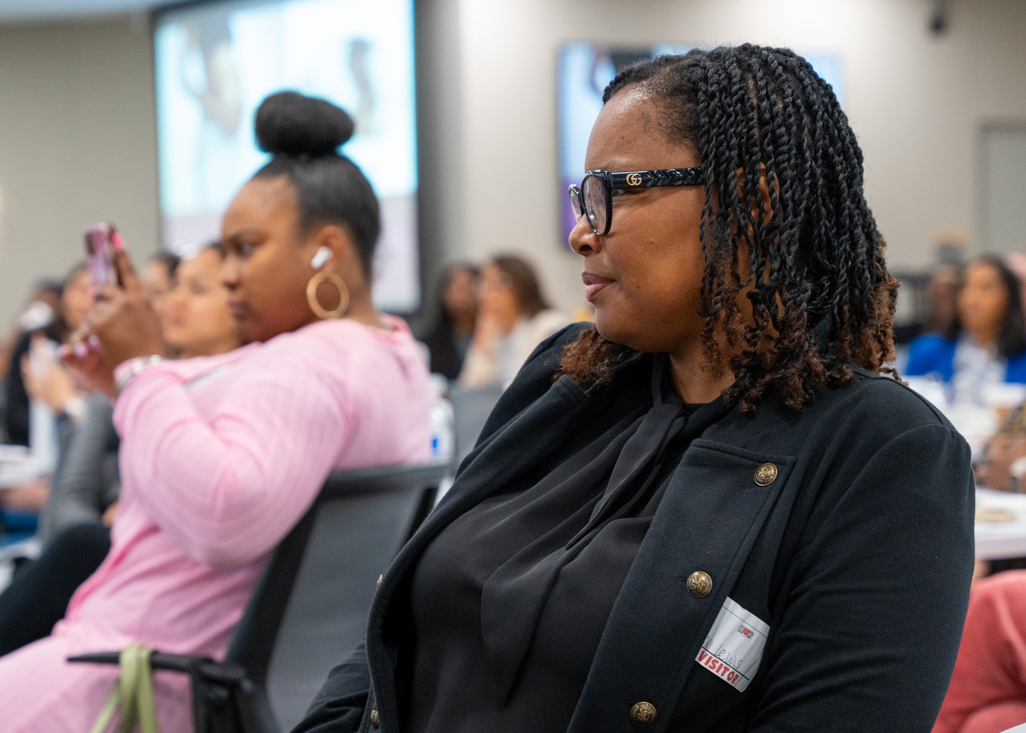 A woman listening in to the panel discussion intently.