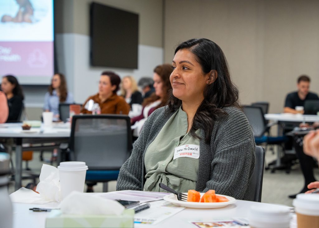 A woman listening in to the panel discussion intently.