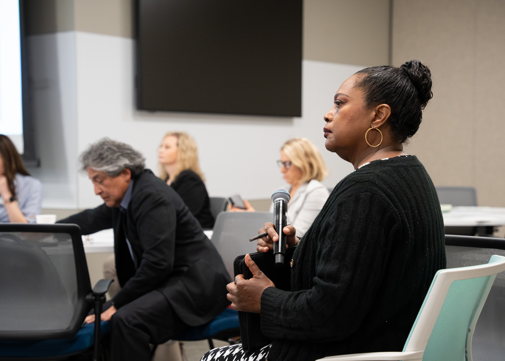 A woman listening in to the panel discussion intently.