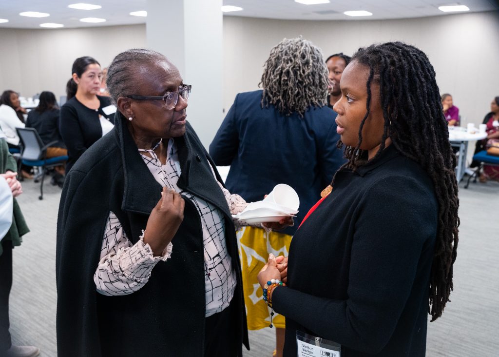 Two women talking at the 2024 Perinatal Equity Initiative (PEI) Provider and Community Summit